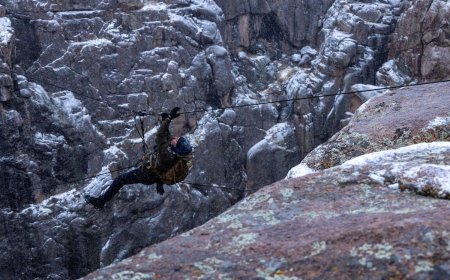 WATCH: Bradley Cooper Dangles over Ravine in this Exclusive ‘Running Wild’ Clip