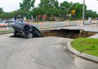 Stunning Footage Shows Moment Two Cars Fall Into Sinkhole