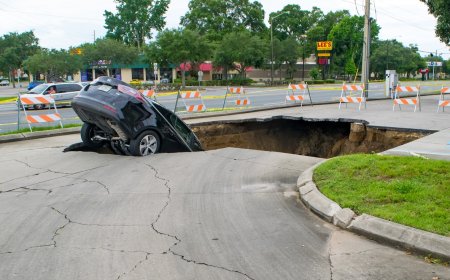 Stunning Footage Shows Moment Two Cars Fall Into Sinkhole