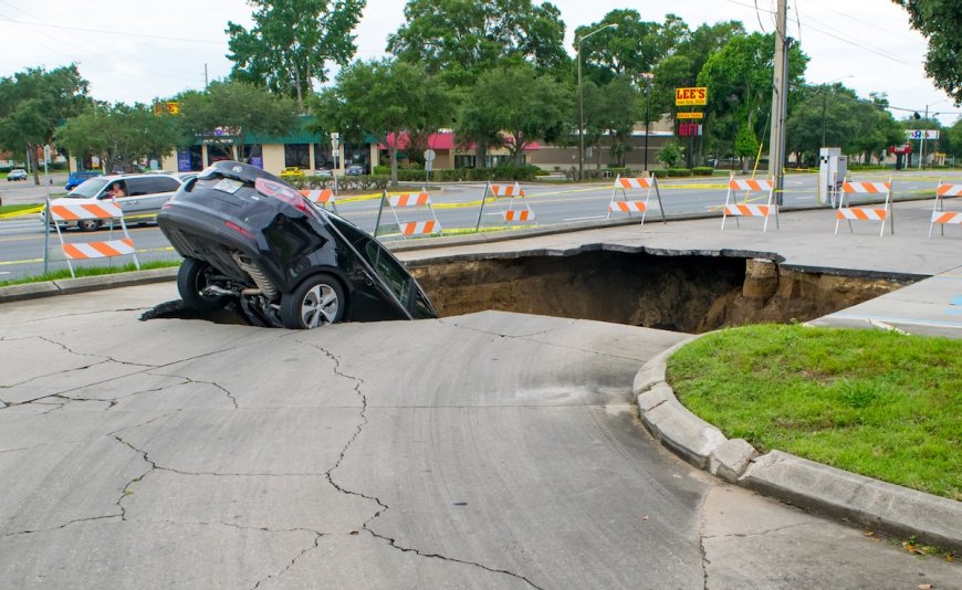 Stunning Footage Shows Moment Two Cars Fall Into Sinkhole